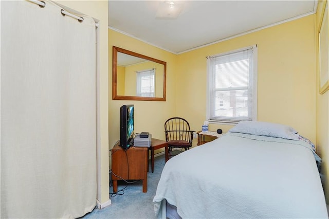 bedroom with ornamental molding and carpet floors