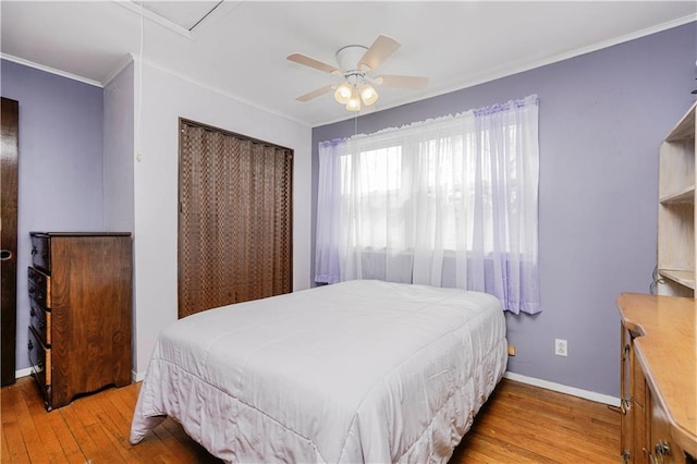 bedroom featuring ceiling fan, baseboards, wood finished floors, and ornamental molding