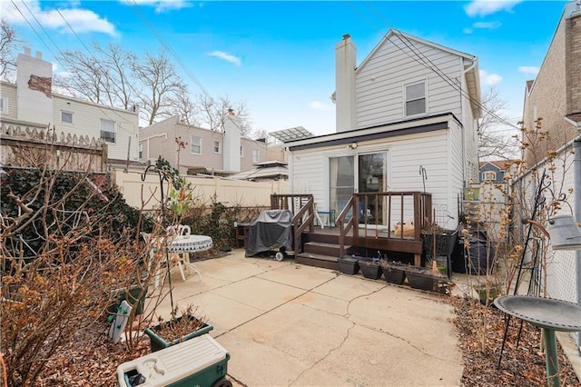 rear view of property with a patio area and a fenced backyard