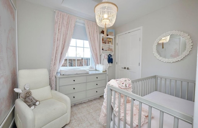 97 Battery Ave Unit 3B, Brooklyn, NY 11209 - bedroom featuring a chandelier and a crib