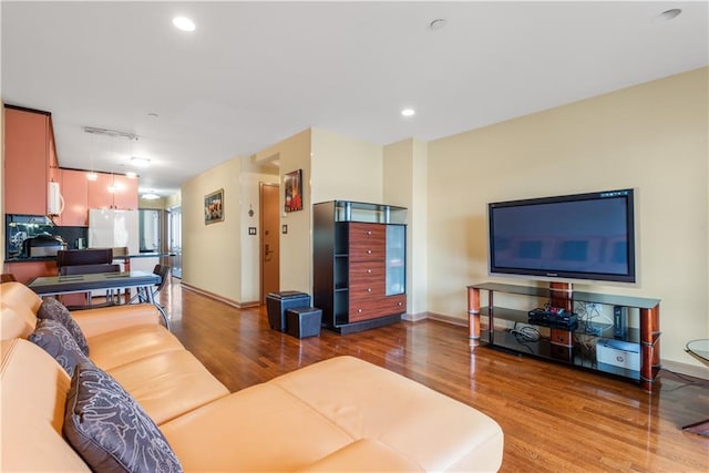 living room with recessed lighting, rail lighting, baseboards, and wood finished floors