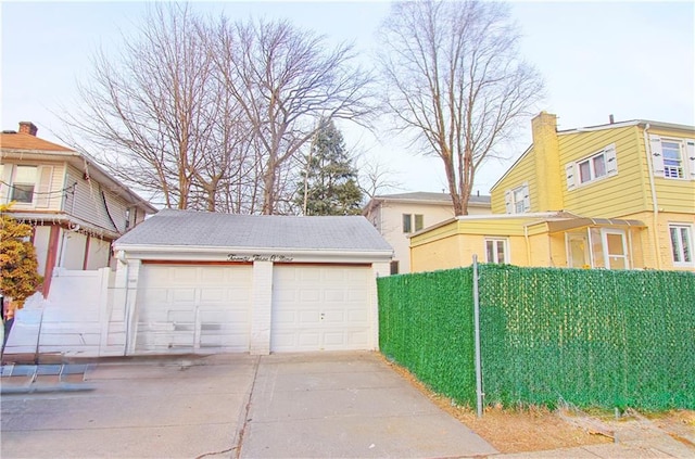 detached garage featuring fence