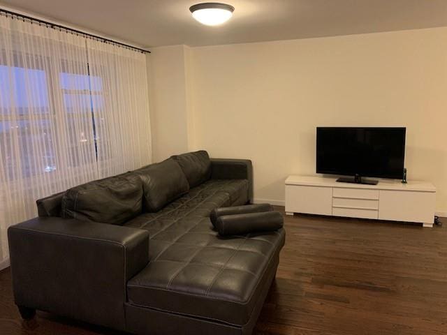 living area with wood finished floors and baseboards