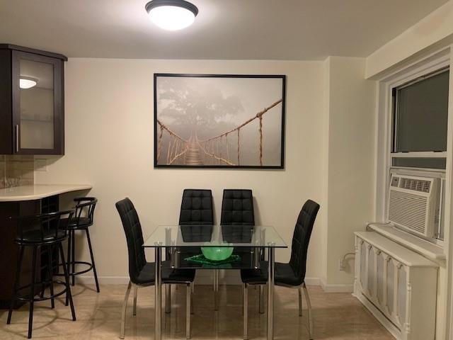 dining space with cooling unit and baseboards