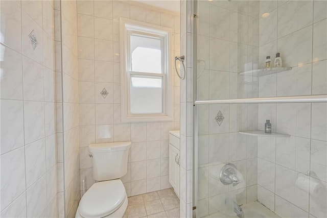 full bath featuring tile walls, toilet, and tile patterned floors