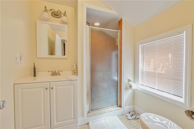 full bathroom featuring a shower stall, baseboards, and vanity