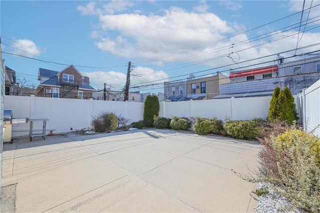 view of patio / terrace featuring fence and a residential view
