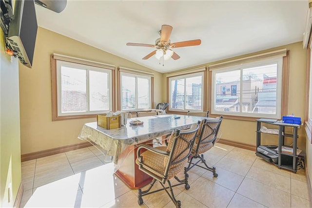 dining room with lofted ceiling, a ceiling fan, light tile patterned floors, and baseboards