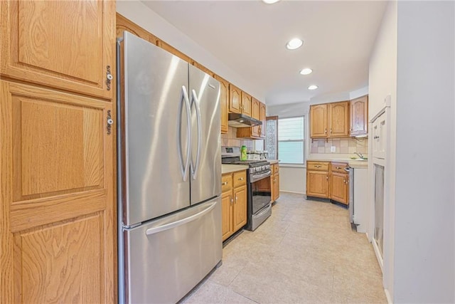 kitchen with recessed lighting, stainless steel appliances, backsplash, and light countertops