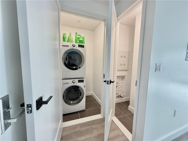 1238 63rd St Unit D301, Brooklyn, NY 11219 - laundry area with stacked washing machine and dryer, baseboards, and tile patterned floors