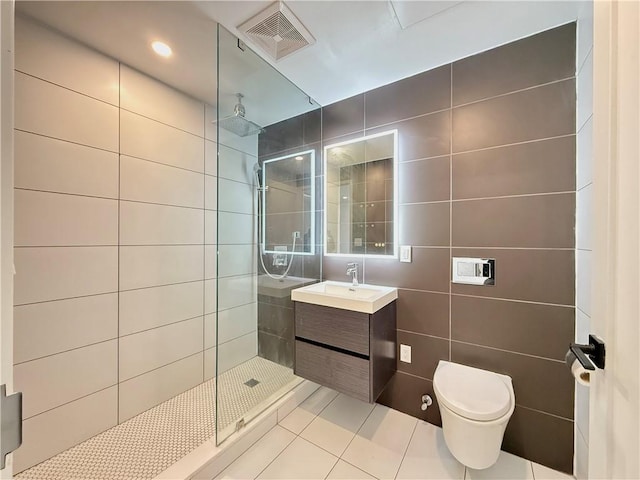 1238 63rd St Unit D301, Brooklyn, NY 11219 - full bathroom featuring tile walls, a walk in shower, tile patterned flooring, vanity, and toilet
