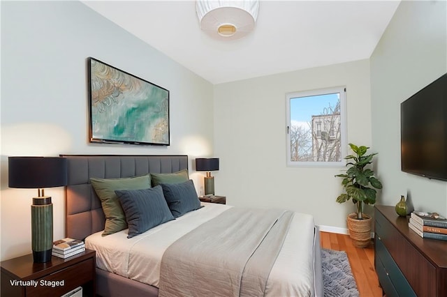 bedroom with light wood-style flooring and baseboards