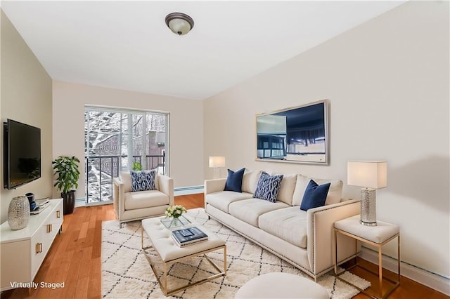 living room featuring light wood-type flooring and baseboards