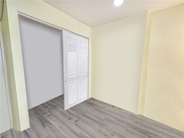 unfurnished bedroom with a closet and wood finished floors