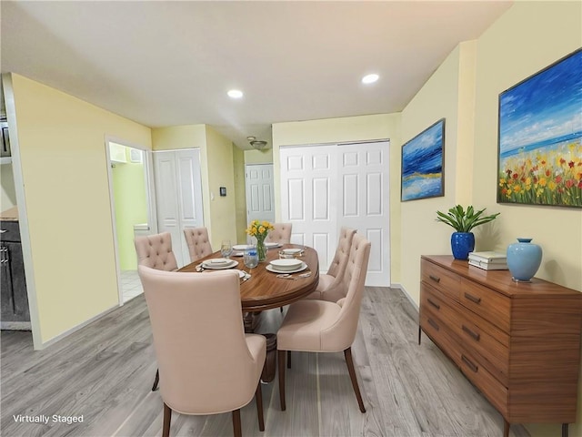 dining room with recessed lighting, baseboards, and light wood finished floors