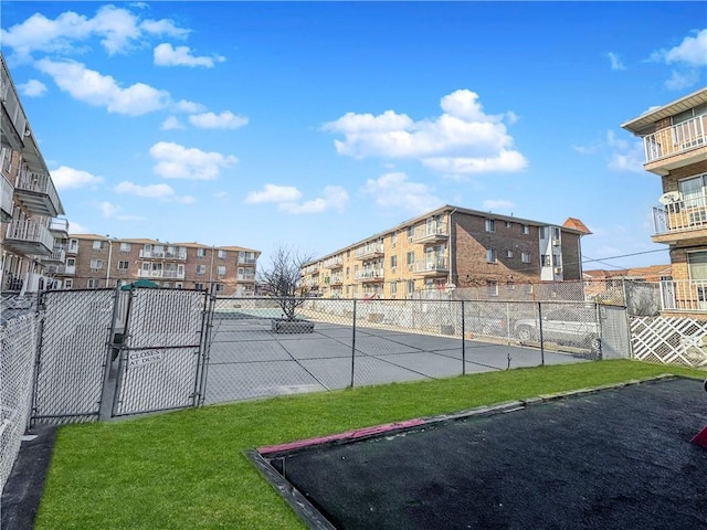 surrounding community with a gate, a lawn, and fence