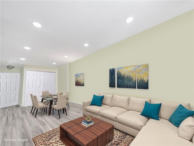 living room with recessed lighting, light wood-style floors, and baseboards