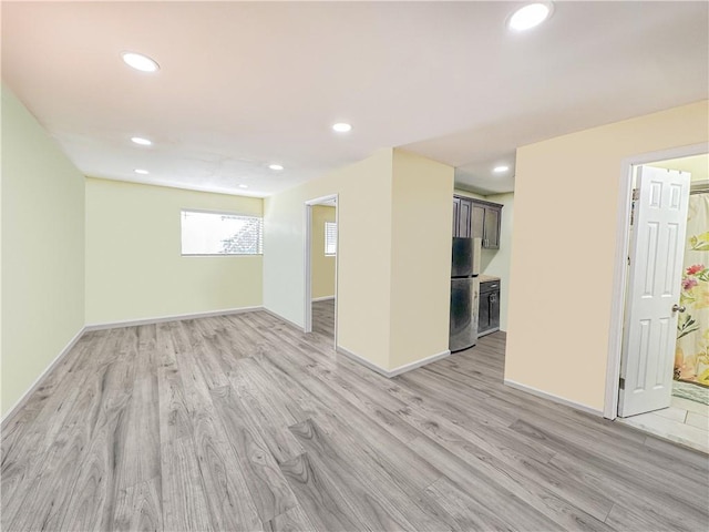 unfurnished room with recessed lighting, baseboards, and light wood-style floors