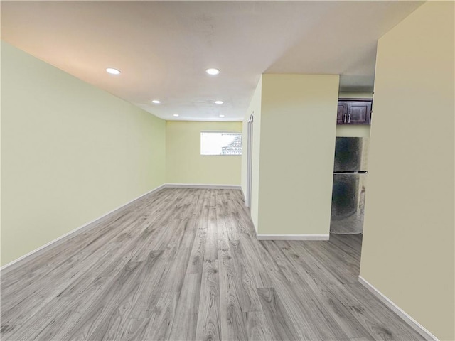 basement featuring recessed lighting, light wood-type flooring, and baseboards