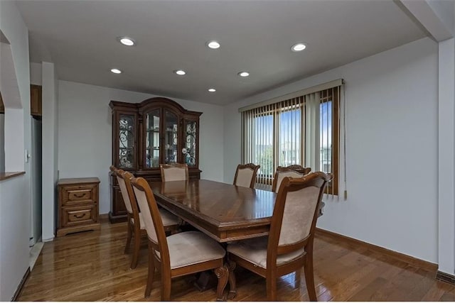 dining room featuring recessed lighting, baseboards, and wood finished floors