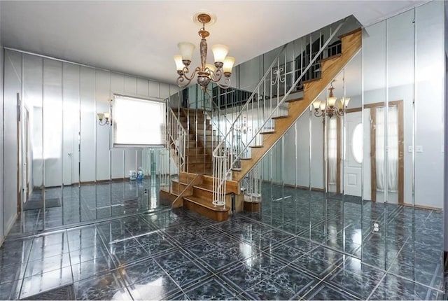 stairway with a notable chandelier