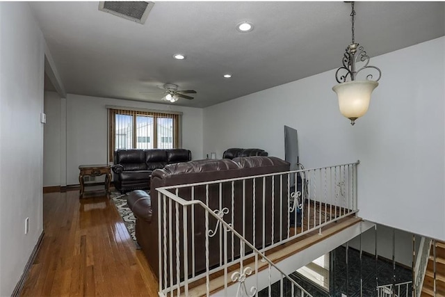 living room featuring visible vents, a ceiling fan, wood finished floors, recessed lighting, and baseboards