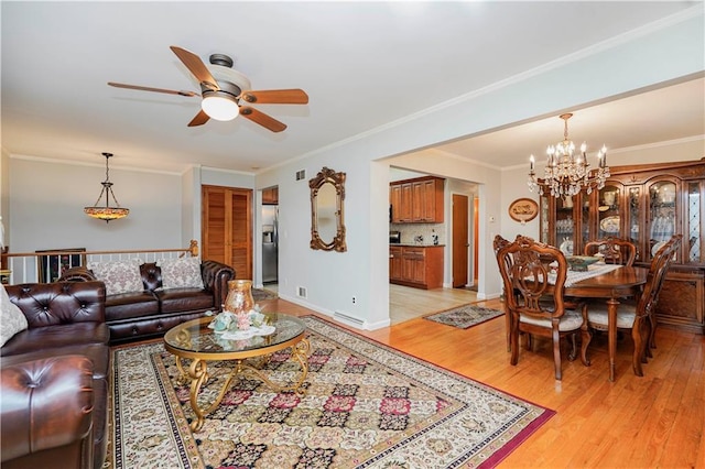 living area with ornamental molding, light wood-type flooring, baseboards, and ceiling fan with notable chandelier