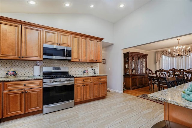 kitchen featuring appliances with stainless steel finishes and brown cabinetry