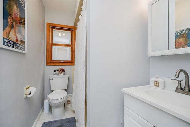 bathroom featuring baseboards, vanity, toilet, and tile patterned floors