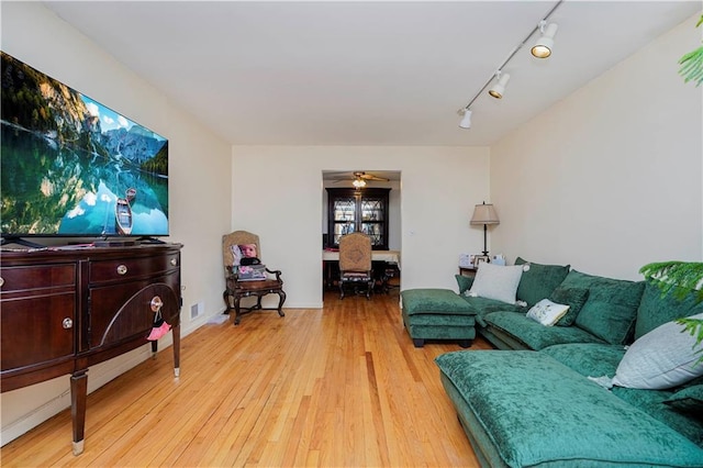 living room with ceiling fan, hardwood / wood-style floors, and visible vents