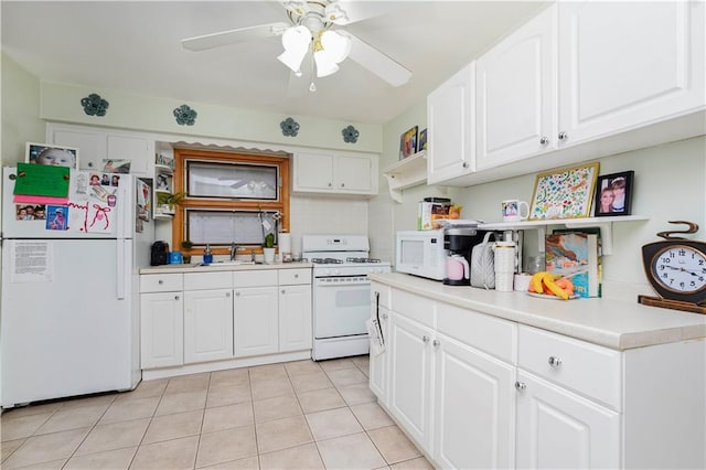 kitchen with white appliances, a sink, light countertops, white cabinetry, and backsplash