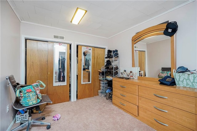 bedroom featuring carpet floors, visible vents, and crown molding