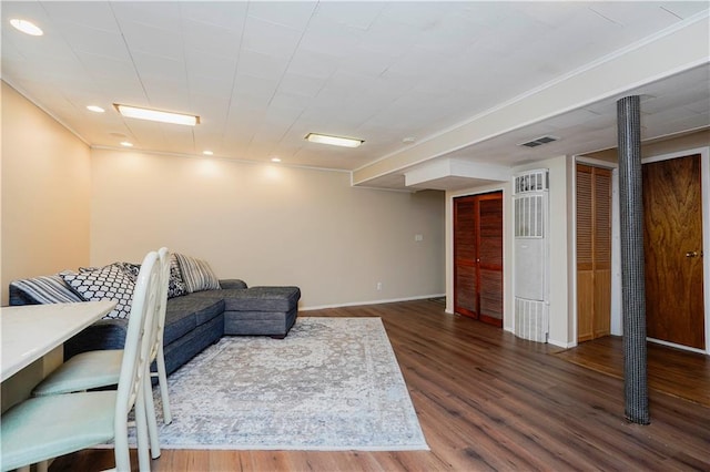 living area with baseboards, visible vents, wood finished floors, and recessed lighting