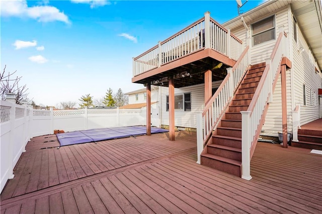 deck featuring stairs and fence