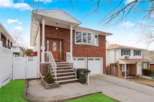 view of front facade featuring a garage, brick siding, fence, concrete driveway, and a gate