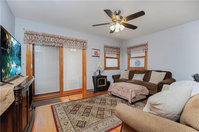 living room with light wood-style floors and a ceiling fan