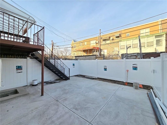 view of patio / terrace with fence and stairway