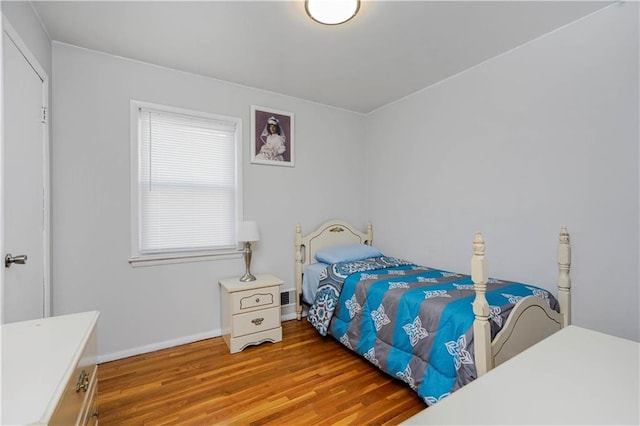 bedroom featuring baseboards and wood finished floors