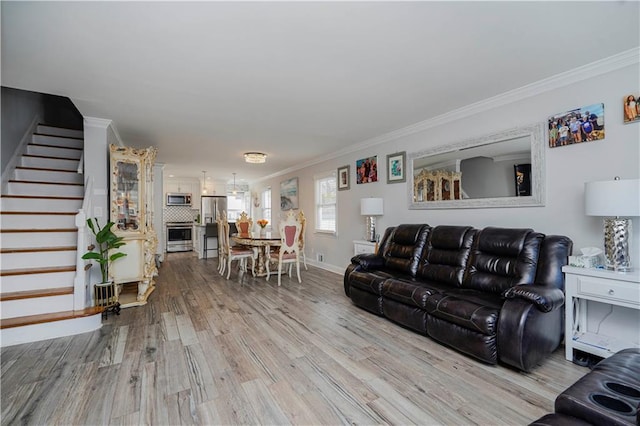 living room featuring stairway, ornamental molding, baseboards, and wood finished floors