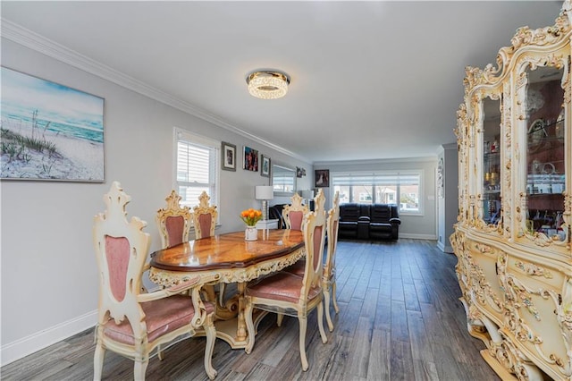 dining room with wood finished floors and crown molding