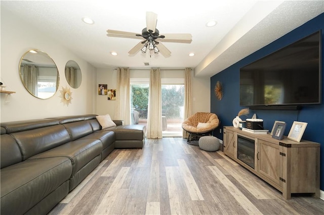 living room with recessed lighting, light wood-type flooring, and a ceiling fan