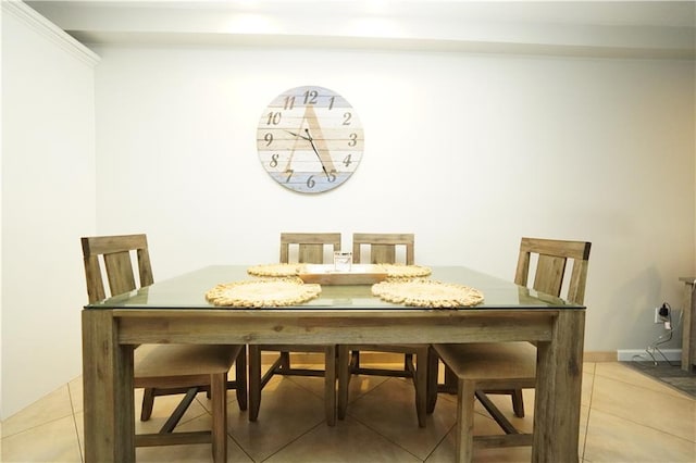 dining room with light tile patterned flooring and baseboards