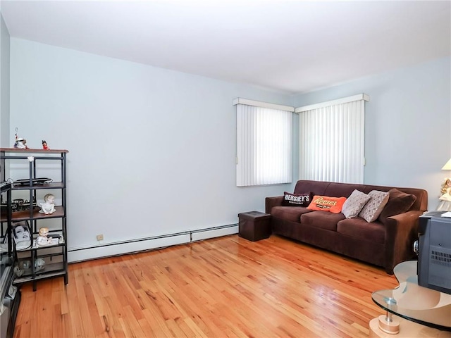 living area featuring baseboard heating and wood finished floors