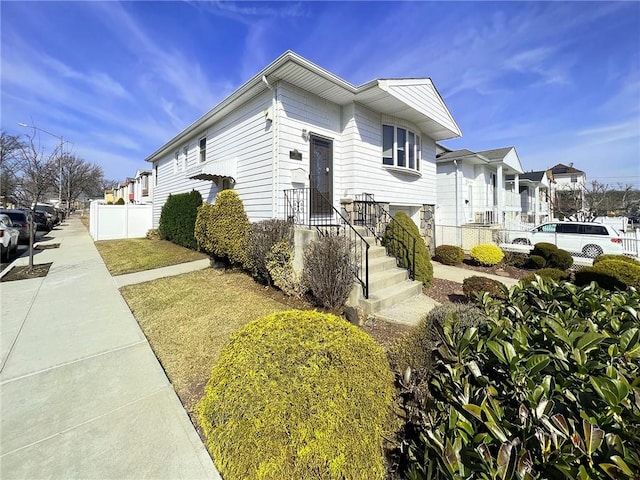 view of front of home featuring fence