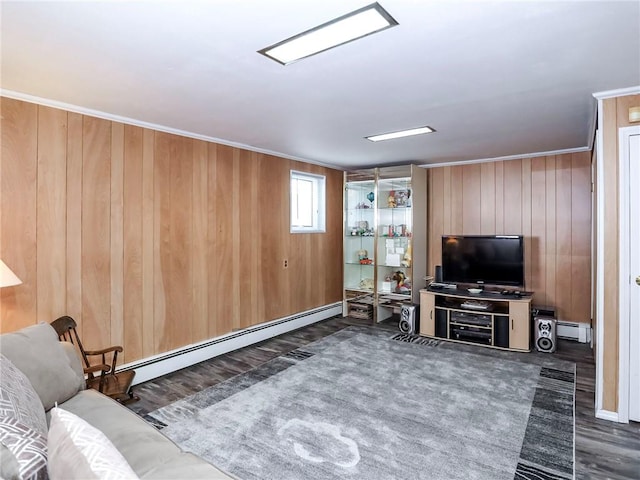 living room with dark wood finished floors, wooden walls, and baseboard heating