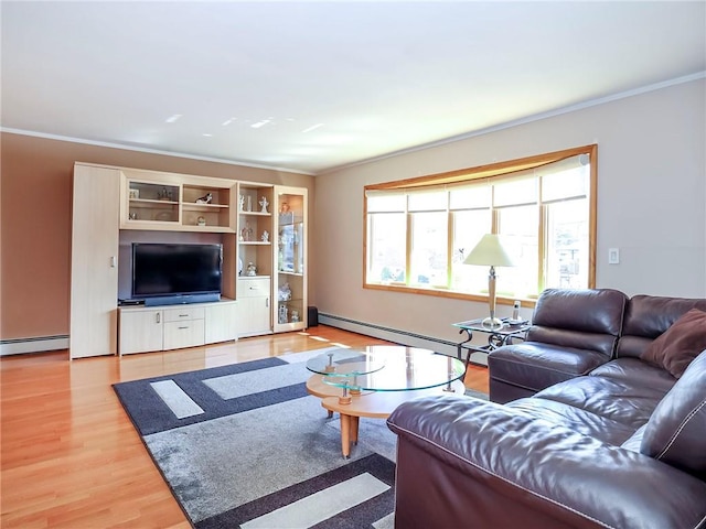 living room featuring a baseboard heating unit, ornamental molding, and light wood-style floors