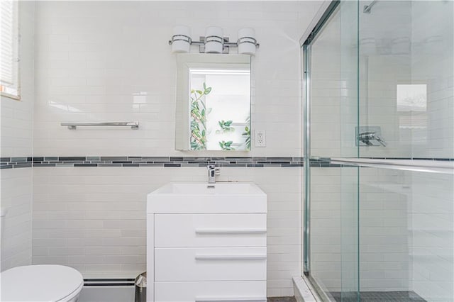 full bath featuring vanity, a shower stall, toilet, and tile walls