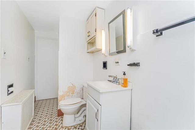 bathroom featuring tile patterned floors, toilet, vanity, and radiator heating unit