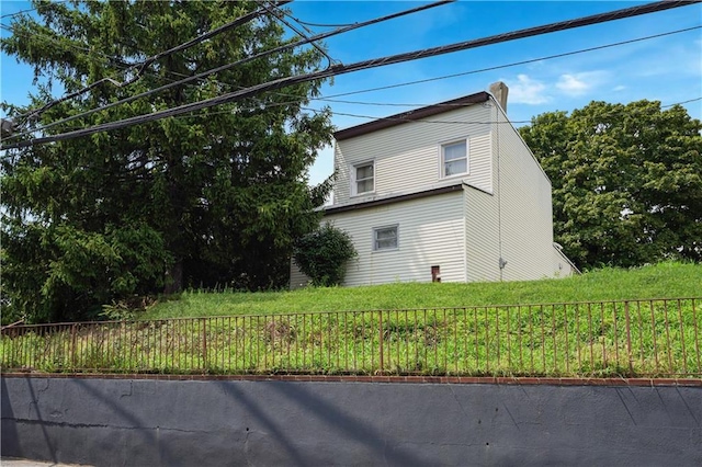 view of home's exterior with fence