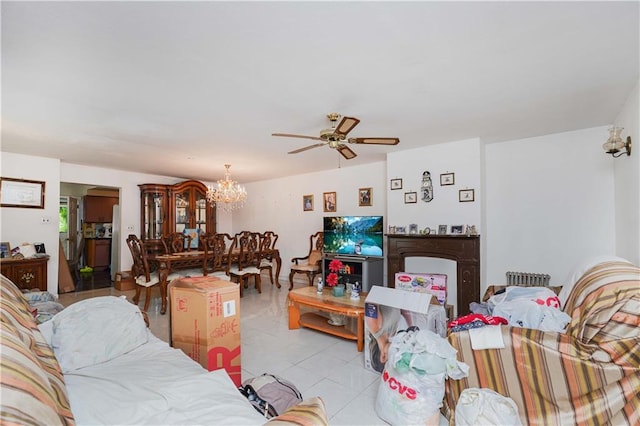 living area featuring ceiling fan with notable chandelier and light tile patterned flooring